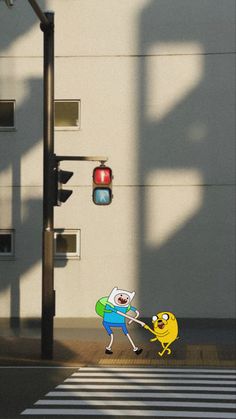 an animated character holding onto another character in front of a traffic light on a city street