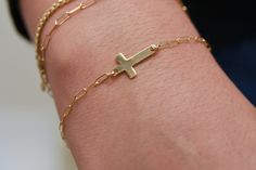 Help her keep her faith and beliefs close with this beautiful and dainty sideways cross bracelet. It's a simple, yet meaningful symbol of her faith that she can wear every day, and a perfect way to celebrate your eternal bond with your blood or soul sister. This Noah cross jewelry comes in your choice of 14k Gold Filled or 925 Sterling Silver and is adjustable between 7" - 8". These lengths work on practically anyone! The paperclip style chain is dainty but strong, and the classic cross charm measures 16.9mm x 9.3mm - perfect size for everyday wear! Confirmation Jewelry, Faith Based Jewelry, Quinceanera Gifts, Stocking Stuffers For Her, Friends Bridal, Bracelet For Her, Everyday Bracelet, First Communion Gifts, Communion Gifts