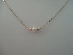 This necklace has a 6mm vintage pearl from my early 1970's collection in the center of 14k solid gold beads and 1.3mm wide sparkly sequin chain with a 14k solid gold lobster claw clasp. White Pearl Drop Necklace In 14k Gold, Dainty Pearl Jewelry With Birthstone, White Single Strand 14k Gold Necklace, Single Strand 14k Gold White Necklace, Gift White Pearl Necklace In 14k Gold, White Pearl Necklace With Delicate 14k Gold Chain, Gold Pearl Birthstone Jewelry, Formal White 14k Gold Filled Necklaces, Formal White 14k Gold-filled Necklace