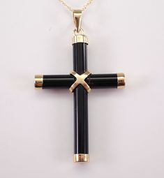 14K Yellow Gold Black Onyx Cross Pendant Charm Necklace. This cross is set with genuine Black Onyx.  This pendant is 14KT Yellow Gold, comes with an 18" 14K Yellow Gold chain and together with the chain weighs 1.9 grams. This cross measures 30 X 21 mm without the bail.  I will ship this pendant promptly in a beautiful gift box. ADDITIONAL REQUESTS If you would like to see more pictures of this item, please let us know and we would be happy to provide them for you. Please contact us with all ques Black Cross Pendant For Formal Occasions, Elegant Black Crucifix Jewelry, Onyx Cross Jewelry Gift, Onyx Cross Jewelry As A Gift, Black Polished Cross Jewelry, Black Cross Pendant Necklace For Formal Occasions, Elegant Black Cross Necklace Gift, Elegant Black Crucifix Cross Necklace, Black Cross Jewelry For Formal Occasions