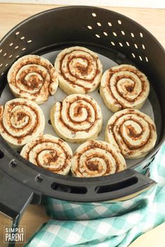 cinnamon buns in an air fryer basket ready to be cooked