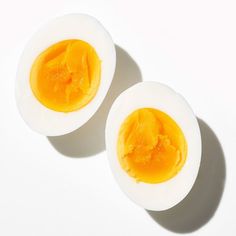 two halves of an egg on a white surface