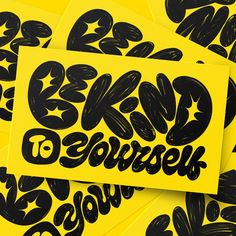 black and yellow stickers with the words be kind to yourself written on one side