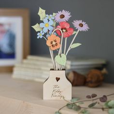 there is a vase with flowers in it on the table