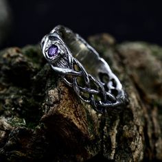 Crafted from sterling silver, our Fairy Nature-Inspired Ring with Branch and Leaves is a unique and enchanting piece that captures the magic of the forest. Adorned with an amethyst and featuring intricate details of branches and leaves, this ring is perfect for those seeking a nature-inspired and fantasy forest wedding ring. The celtic braid band adds a touch of elegance to this unique silver jewelry, making it an ideal choice for elven bridal jewelry or a fairycore ring that symbolizes the enchantment of the woodland.  Characteristics: Metal - Recycled solid sterling silver  Stone - Cubic Zirconia 2.5 mm Finish - Oxidized. View all silver fairy rings: https://www.etsy.com/shop/TinyShinyJewel?ref=seller-platform-mcnav&section_id=44320998 Care instructions: To care for the ring, avoid conta Sterling Silver Fantasy Style Promise Ring, Fantasy Silver Rings For Anniversary, Silver Fantasy Rings For Anniversary, Fantasy Style Silver Ring For Anniversary, Adjustable Silver Magical Style Rings, Mystical Silver Promise Ring, Mystical Style Silver Promise Ring, Mystical Silver Rings For Weddings, Mystical Silver Ring For Anniversary