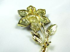 "Beautiful vintage brooch . I bought this pin from an older lady who said she had it since the 1950-60s. Set in gold tone metal are beautiful flower petals of amethyst colored rhinestones and a beautiful iridescent turquoise around the center.perfect condition. Very good quality. Size is 2\"wide x 2.5\" tall. Beautiful! One of my favorite." Collectible Gold Flower Enamel Pin, 1950s Jewelry, Amethyst Color, Brooch Vintage, Vintage Brooch, Who Said, Beautiful Flower, Flower Petals, Gold Tone Metal