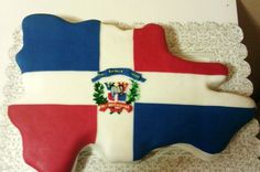 a cake shaped like the state of texas with flag and coat of arms on it