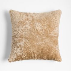 a beige pillow on a white background