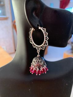 A very Ornate Pair of Sterling Silver Jhumkas are paired with Ruby Red Swarovski Crystals, these dangle from very  ornate Lotus Shaped( Kamala or Padma) hoops.  The pairing of jhumkas with hoops give these an exotic look. The ruby red crystals are very romantic and are great for the hot summer ahead. These are famous in Jaipur, Rajasthan and all over India. Pair this with any outfit you can dream of, you'll love these. My only pair don't miss out on these...  Total length is 2". Metal - Sterling Silver Jhumkas, Jaipur Rajasthan, Red Crystals, Ruby Red, Jaipur, Jewelry Earrings Dangle, Swarovski Crystals, Lotus, Etsy Accessories