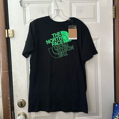 The North Face Graphic Short Sleeve T-Shirt Black/Green New With Tags Size Xxl (18/20) Stock: Teal10 The North Face Cotton Short Sleeve T-shirt, The North Face Crew Neck Top With Letter Print, The North Face Cotton Graphic T-shirt, The North Face Cotton Graphic Tee, The North Face Letter Print Streetwear Tops, The North Face Graphic Print Tops For Streetwear, The North Face Short Sleeve Relaxed Fit Tops, The North Face Crew Neck Top For Summer, The North Face Relaxed Fit Short Sleeve Top