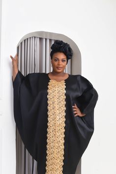 Mums are the best, lets celebrate us with our new collection of luxury Mikado Kaftan Boubou. One size fits all featuring detail gold applique running from neckline to hem, they are comfortable, soft on the skin and perfect for this special celebration. Handmade with Mikado and designed to make you feel trendy and fashionable giving rich African aunty vibes Product Details Style: Boubou Bubu Kaftan Fit: Loose Round neck Length 58" Material: Mikado Colour: Black Care Instructions: Hand wash cold.