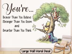 a winnie the pooh wall decal with an image of a tree and two teddy bears