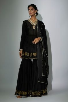 Black peplum anarkali with zardosi and marodi embroidered neckline. Paired with a gharara and embroidered dupatta. - Aza Fashions Elegant Ceremonial Sets With Gota Work, Elegant Black Anarkali Set With Gota Work, Elegant Black Sharara With Gota Work, Ceremonial Bollywood Sharara With Zari Work, Ceremonial Sharara With Dupatta For Eid, Eid Ceremonial Sharara With Dupatta, Elegant Ceremonial Sharara For Eid, Bollywood Style Ceremonial Salwar Kameez With Gota Work, Ceremonial Sharara With Cutdana For Eid