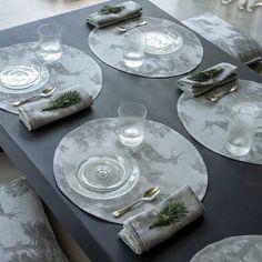 the table is set with place settings and silverware