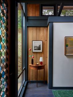 a room with wood paneling and glass doors that lead to the outside patio area