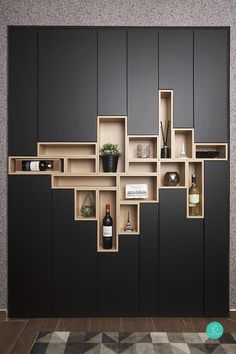 a room with black cabinets and shelves filled with bottles