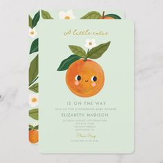 an orange with leaves and flowers on it's face is in the middle of a card