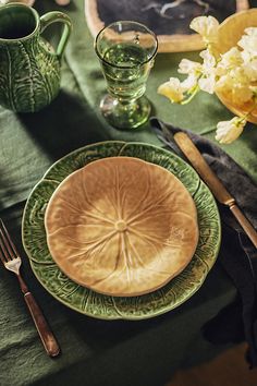 a table set with plates, cups and utensils