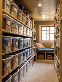 an organized pantry with clear bins and lots of items on the shelves in it