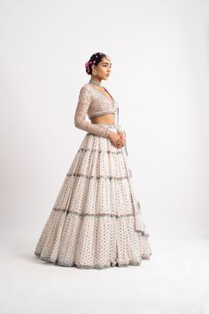 Intricately hand embroidered multi-color V neck blouse with multi-tier hand embroidered lehenga and a beautiful mirror work dupatta.From Vvani Vats Rang's collection.DELIVERY TIMEPlease allow 8-12 weeks for your outfit to arrive.FABRIC DETAILSNet, Georgette, Silk BlendProfessional cleaning only. Multi Color Lehenga, Mirror Work Dupatta, Embroidery Rose, Blouse Lehenga, Net Blouse, Lehenga Dupatta, Net Blouses, Georgette Dupatta, Beautiful Mirror