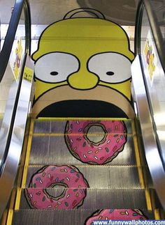 an escalator decorated with cartoon characters and donuts