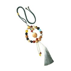 a necklace with beads and tassels hanging from it's side on a white background