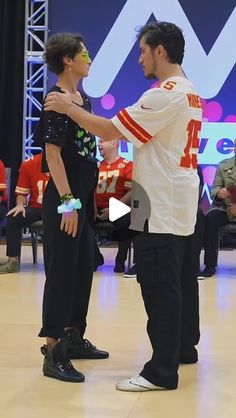 a man and woman dancing on a dance floor