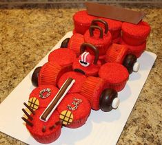 a cake made to look like a race car with red frosting and chocolate decorations