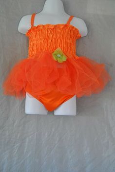 Toddler dress size 6-12 months, orange in color and has a green flower on the front. The dress slips overhead the dress is sleeveless. The bottom of the dress has lace all around it. Comes with underpants orange in color. For more great items please visit us at:https://www.ebay.com/str/maggieandsampson6 Orange Summer Party Tutu Dress, Summer Stretch Tutu Dress With Ruffles, Stretch Summer Tutu Dress With Ruffles, Fitted Cotton Tutu Dress For Summer, Orange Summer Dress For Dress-up, Orange Summer Dress For Dress-up Occasion, Orange Summer Dresses For Casual Wear, Orange Outfit, Dress Orange