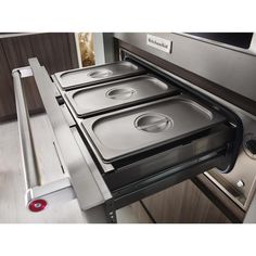 an oven with four pans in it