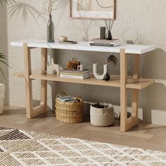 a white marble top console table with two shelves and baskets on the floor in front of it