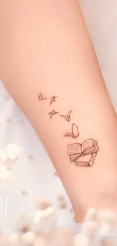 30 BEAUTIFUL BOOK TATTOOS THAT WILL INSPIRE YOU! Cute Small Book Tattoos, Small Reader Tattoo, Bird Book Tattoo, Book To Bird Tattoo, Verity Tattoo Designs, Literary Quotes Tattoos, Heart Book Tattoo, Books And Birds Tattoo, Cute Book Tattoos For Women