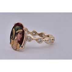 This is part of Chairish’s Fine Jewelry assortment.  Enamel Faced Portrait of Athena Ring 14K  This ring has a beautiful face of Athena a Roman goddess.  This started life as a Stick pin but I couldn't help myself I had to turn this into a ring.  The face is beautiful with a tiny Diamond on her ear.  The band is set with ten 0.10 point Diamonds circling the band. Colors are beautiful it weighs in at 6.09 grams and is a size 5 3/4. This ring is perfect for those with smaller fingers or it can be 14k Gold Oval Enamel Ring For Anniversary, Oval 14k Gold Enamel Ring For Anniversary, Oval Enamel Ring With Rose Cut Diamonds For Wedding, Oval Diamond Enamel Wedding Ring, Collectible Fine Jewelry Rings With Bezel Setting, Unique Collectible Diamond Rings, Oval Diamond Ring For Collectible, Gold Diamond Ring With Cabochon For Gifts, Oval Diamond Ring For Collectors