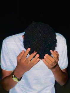 a person covering their face with his hands