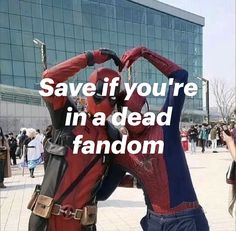 two people dressed up as deadpools in front of a building with text saying save if you're in a dead fandom