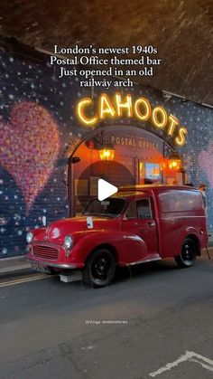 an old red truck parked in front of a building with a sign that says cahoots