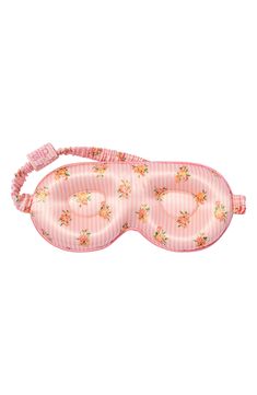 a pink sleeping mask with flowers on it