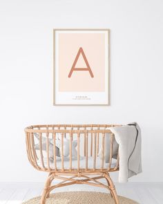 a baby's room with a wicker crib and a framed letter on the wall