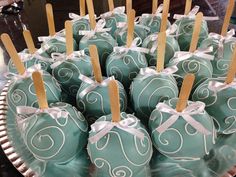 chocolate covered candies with toothpicks tied in white ribbons on a silver platter