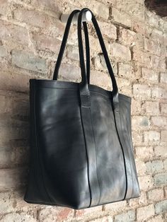 The perfect large carry all bag that will allow to throw in whatever you need to carry with a super stylish look :) Oversized black leather bag, with zipper and inside lining, 1 zippered pocket and 3 open pockets, to keep smaller items separated from the large compartment. If you need a different combination of inside pockets we can also make it :) It's a very versatile bag, you can use it as a weekender, work bag, or a classy diaper bag, with its several pockets, you can have everything organiz Black Hobo Bag With Leather Lining, Black Leather Lined Hobo Tote Bag, Black Leather-lined Hobo Bag In Tote Shape, Black Leather Lining Hobo Tote Bag, Black Leather-lined Tote Hobo Bag, Black Shoulder Bag With Leather Lining And Double Handle, Classic Black Leather Hobo Bag, Black Leather Lined Tote Bag, Black Rectangular Leather Bucket Bag