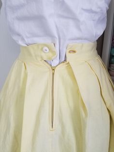 "Sweet little summery skirt! This is made with a buttery yellow textured weave cotton fabric. The skirt is pleated to a flat waistband, and there is a cute border in brown with surface embroidery with hearts. I think it was all hand done! So much time went into this as I believe it to be hand done! This skirt closes in the back with a metal zipper ans a sweet little daisy / flower button! Condition: Very good! One small spot on skirt. On the inside you can see where the brown embroidery thread w Vintage Yellow Lined Skirt, Yellow Retro Pleated Skirt, Retro Yellow Pleated Skirt, Vintage Cotton Pleated Skirt, Vintage Pleated Cotton Skirt, Vintage Yellow Cotton Skirt, Dress And Jacket Set, Yellow Textures, Embroidered Heart