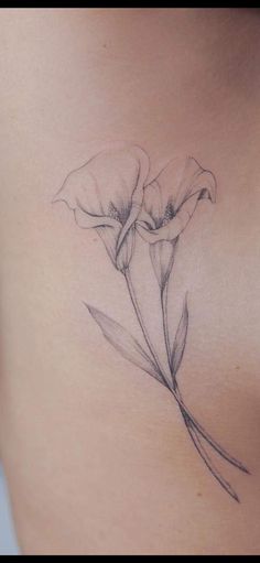 a woman's stomach with a flower tattoo on it