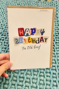 someone holding up a birthday card with the words happy birthday ya old bag