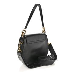 This is an authentic CHLOE Calfskin Suede Large Tess Bag in Black. This versatile bag is crafted of black calfskin leather with black suede trim. The bag features a removable black leather top handle, a removable, adjustable black leather shoulder strap, and a prominent gold-toned decorative ring on the front. The flap opens with a magnetic snap to a front pocket and an off-white fabric interior with a leather patch pocket. Black Leather Top, Leather Patches, White Fabric, White Fabrics, Leather Top, Black Suede, Front Pocket, Top Handle, Patch Pocket