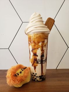 an ice cream sundae and a stuffed animal on a table