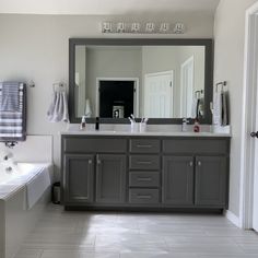 a large bathroom with two sinks and a bathtub