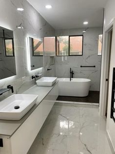 a large bathroom with two sinks and a bathtub