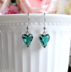 Simple and lovely heart charm necklace and earrings feature teal green Cubic Zirconia pendant/drop in silver setting.  Pendant/drop hang from a dainty silver plated brass chain/earwires.Delightful to wear.  Pendant/drop size: 9 mm x 14 mm (including loop) Total earrings length: 30 mm Purchase over $40 enjoys free shipping! Coupon code 'freeshipping1'.       Free Gift Wrapping on request - All items that are gift wrapped come in with a kraft box with raffia string and blank writing card.  Please leave a note if you need it upon ordering. Green Heart Necklace, Dainty Silver Necklace, Heart Charm Necklace, Green Pendant, Green Pendants, Zirconia Necklace, Cubic Zirconia Necklace, Green Heart, Necklace And Earrings Set