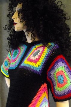 a crocheted top with multicolored squares on the front and sides, made to look like a woman's head