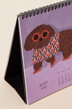 a calendar with an image of a dog wearing sunglasses on it's front cover